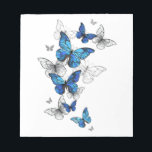 Blue Flying Butterflies Morpho Notepad<br><div class="desc">Flying Blue Butterflies morpho and white butterflies on a light abstract background. Morpho. Design with blue butterflies morpho.</div>