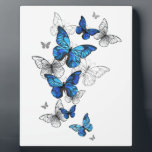 Blue Flying Butterflies Morpho Plaque<br><div class="desc">Flying Blue Butterflies morpho and white butterflies on a light abstract background. Morpho. Design with blue butterflies morpho.</div>