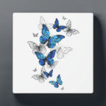Blue Flying Butterflies Morpho Plaque<br><div class="desc">Flying Blue Butterflies morpho and white butterflies on a light abstract background. Morpho. Design with blue butterflies morpho.</div>