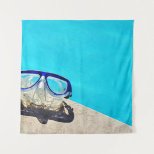 Blue framed swimming goggles near pool at daytime tapestry
