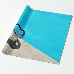 Blue framed swimming goggles near pool at daytime wrapping paper