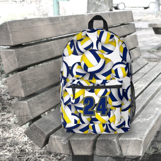 blue gold school colours volleyball player name  printed backpack (Backpack with a volleyball player's jersey number, sitting on an outdoor bench)