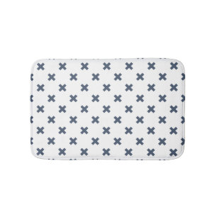 Blue-gray cross stitches on white bath mat
