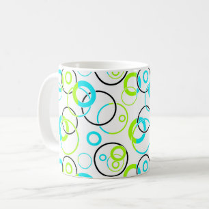 blue green and black rings and circles on white coffee mug