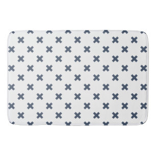 Blue-grey cross stitches on white bath mat