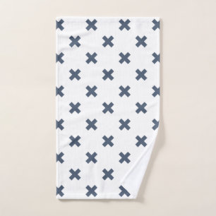 Blue-grey cross stitches on white hand towel