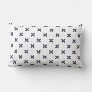 Blue-grey cross stitches on white lumbar cushion