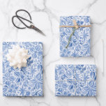 Blue Holiday Floral Wrapping Paper Sheet<br><div class="desc">This festive wrapping paper features flowers,  leaves and stars in blue with a watercolor texture on a white base. The same print is on each sheet in this set.</div>