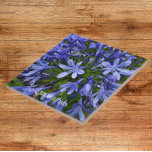 Blue Lily of the Nile Agapanthus Floral Tile<br><div class="desc">Ceramic tile that features a photo image of the bell-shaped,  blue flowers of the Lily-of-the-Nile,  otherwise known as Agapanthus. A lovely,  floral design! Select your tile size. Makes a pretty kitchen trivet!</div>