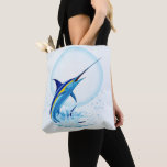 Blue Marlin Jumping out of Ocean Tote Bag<br><div class="desc">Realistic illustration of a beautiful Marlin Fish Ocean Animal jumping out of ocean. Vector Art copyright BluedarkArt TheChameleonArt.</div>