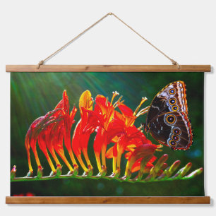 Blue morpho butterfly on Crocosmia Lucifer flowers Hanging Tapestry