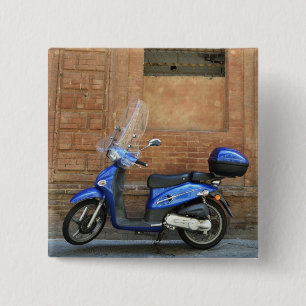 Blue motor scooter by red wall, Siena, Italy 15 Cm Square Badge