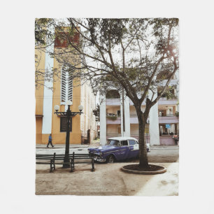 BLUE SEDAN PARKED NEAR WHITE BUILDING FLEECE BLANKET