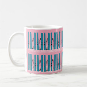 Blue skis on snow with pink coffee mug