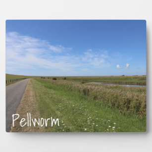 Blue sky above the green island of Pellworm Plaque