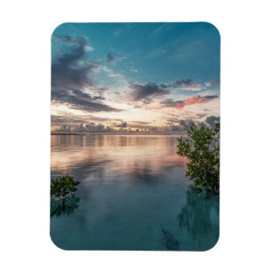 blue sky with red and dark clouds reflected on sea magnet