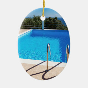 Blue swimming pool with steps at sea ceramic tree decoration
