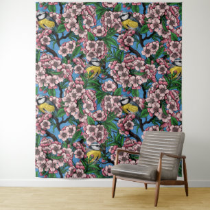 Blue tit birds in the blooming cherry tree on blue tapestry