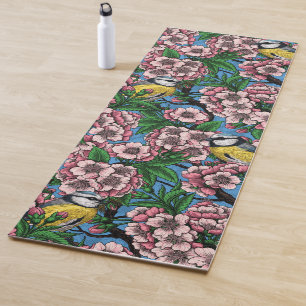 Blue tit birds in the blooming cherry tree on blue yoga mat