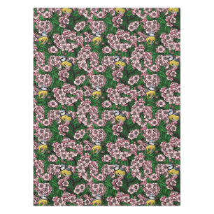 Blue tit birds in the blooming cherry tree on gree tablecloth