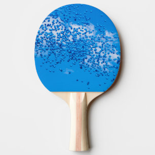 Blue toy balloons in the sky ping pong paddle