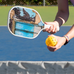 Blue wall and door pickleball paddle