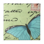 Blue-Winged Butterfly on Teal Postcard Tile<br><div class="desc">This teal postcard carries a message of beauty. A delicate blue-winged butterfly rests on the card, obscuring some of the script it contains. This Vision Studio print would make a great addition to your home!</div>