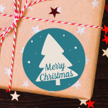 Blue with white pine and snowflake Christmas tree Classic Round Sticker<br><div class="desc">This modern round sticker features a white pine silhouette with little white snowflakes on a flat blue background.
The  customisable words "Merry Christmas" are written in an elegant blue font</div>