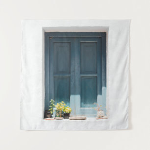BLUE WOODEN DOOR ON WHITE CONCRETE WALL TAPESTRY