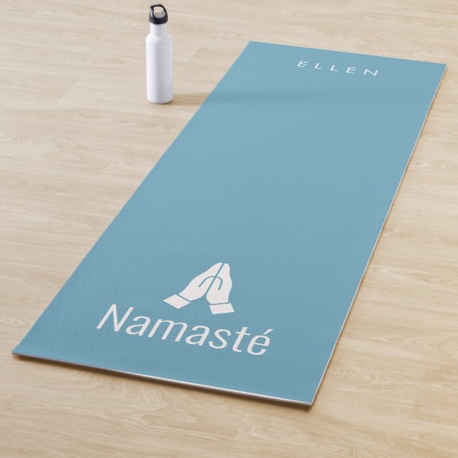 Blue yoga mat with Namasté hands together icon (In Situ)
