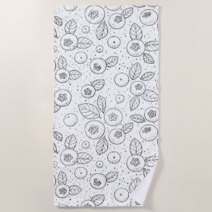 Blueberries on black and white beach towel