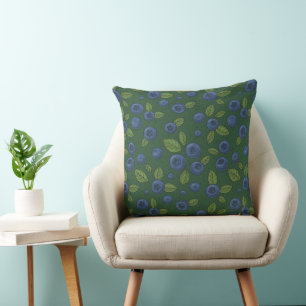 Blueberries on dark green cushion