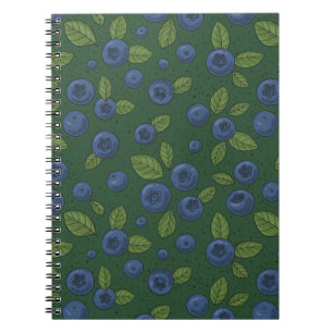 Blueberries on dark green notebook