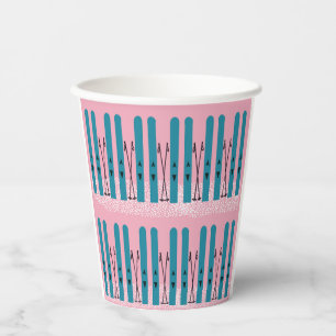 Blues skis on snow with pink background paper cups