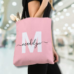 Blush Pink Elegant Script Name Monogram Tote Bag<br><div class="desc">Personalised Girly Blush Pink and White Trendy Modern Script Name Monogram Tote Bag. Add a soft and feminine touch to your everyday style with this chic and playful tote bag. Featuring a blush pink background and a bold white initial (with no shimmer or foil), paired with a sleek black script...</div>