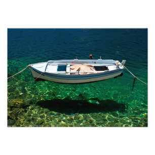 Boat floating on crystal clear water. photo print