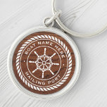 Boat name hailing port nautical ship's wheel wood key ring<br><div class="desc">Keyring featuring a white,  elegant ship's wheel and rope emblem with custom boat name and hailing port (or other custom text) on a printed image of brown wood.</div>