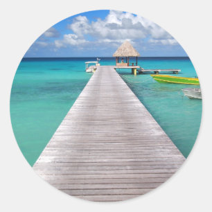 Boats at a jetty in the Pacific round sticker