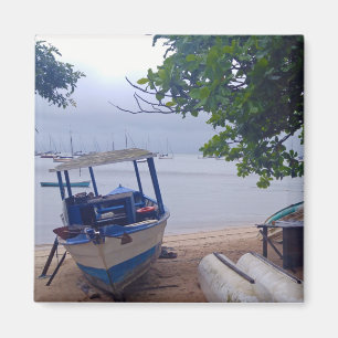 Boats stopped at the beach on a rainy day magnet