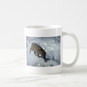 Bobcat on snow coffee mug