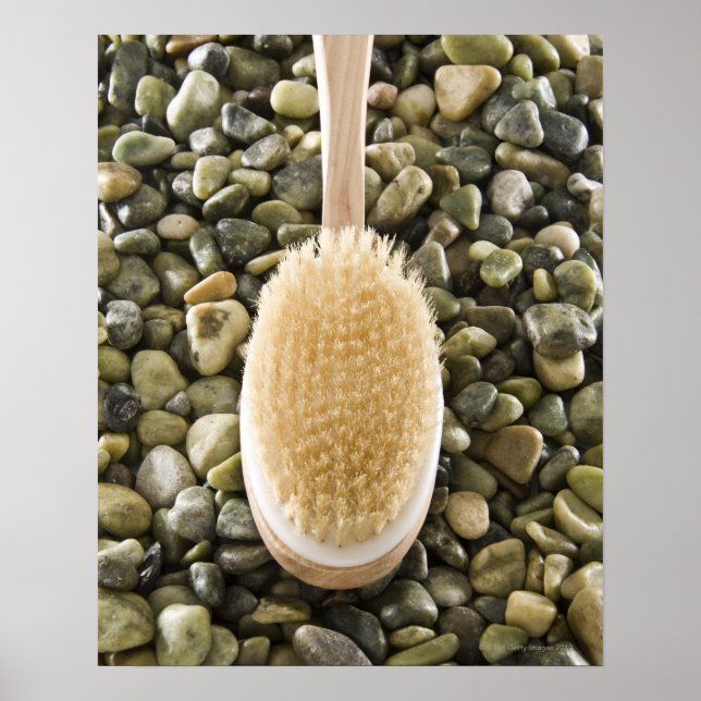 Body scrub brush on rocks poster (Front)
