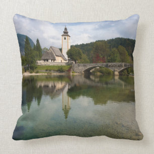 Bohinj lake with church in Slovenia throw pillow