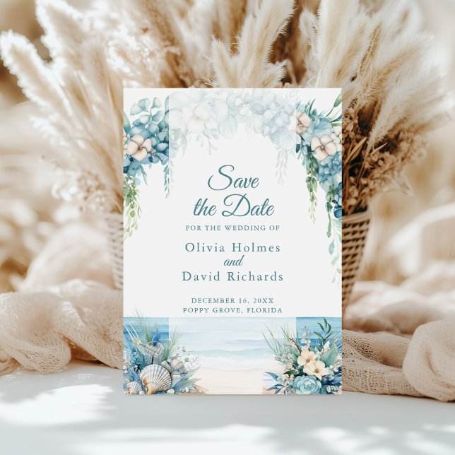Boho Blue Floral Arch Beach Save the Date Card (Boho Blue Floral Arch Beach Save the Date Card on a sunny table in front of white pampas grass)