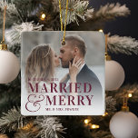 Bold Married & Merry Wedding Photo Newlywed Ceramic Ornament<br><div class="desc">Display a favourite wedding photo with this bold,  modern typography-based Christmas design,  featuring "married & merry" overlaid in burgundy plum lettering joined by an oversized ampersand. Personalise with your wedding date and names. Design repeats on reverse side.</div>