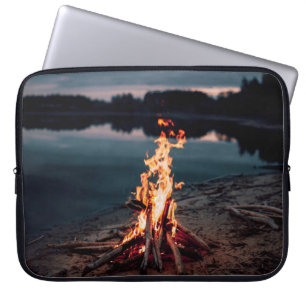 Bonfire near body of water during night time laptop sleeve