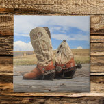 Boots & Spurs Tile<br><div class="desc">A stunning Wyoming sky is the backdrop for this photograph of worn western boots complete with genuine custom made silver spurs,  complete with 1880's Mexican pesos for rowels. A perfect gift idea for the cowboy,  cowgirl,  or anyone who loves the West!</div>