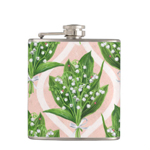 Bouquet of lilly of the valley flowers on green hip flask