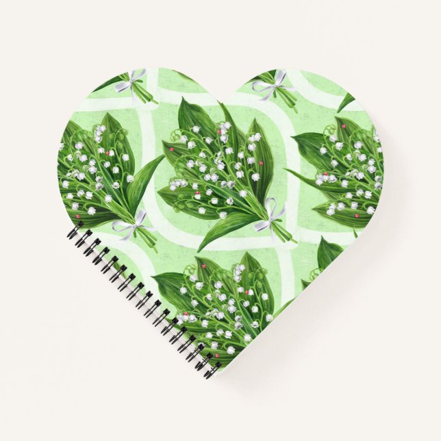 Bouquet of lilly of the valley flowers on green notebook (Front)