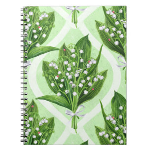 Bouquet of lilly of the valley flowers on green notebook