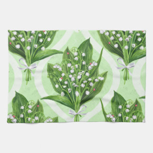Bouquet of lilly of the valley flowers on green tea towel